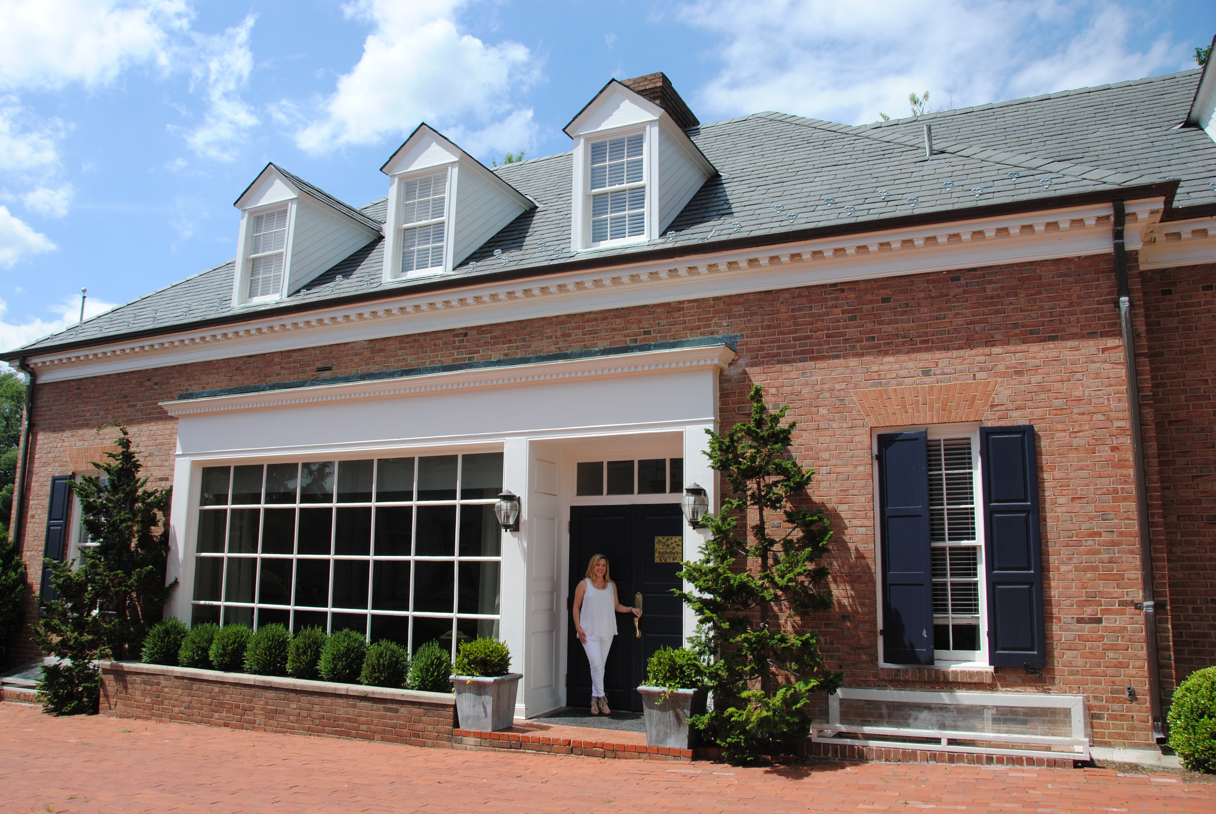 Britt Patterson standing at The Patterson Group Storefront - Alexandria, VA Real Estate